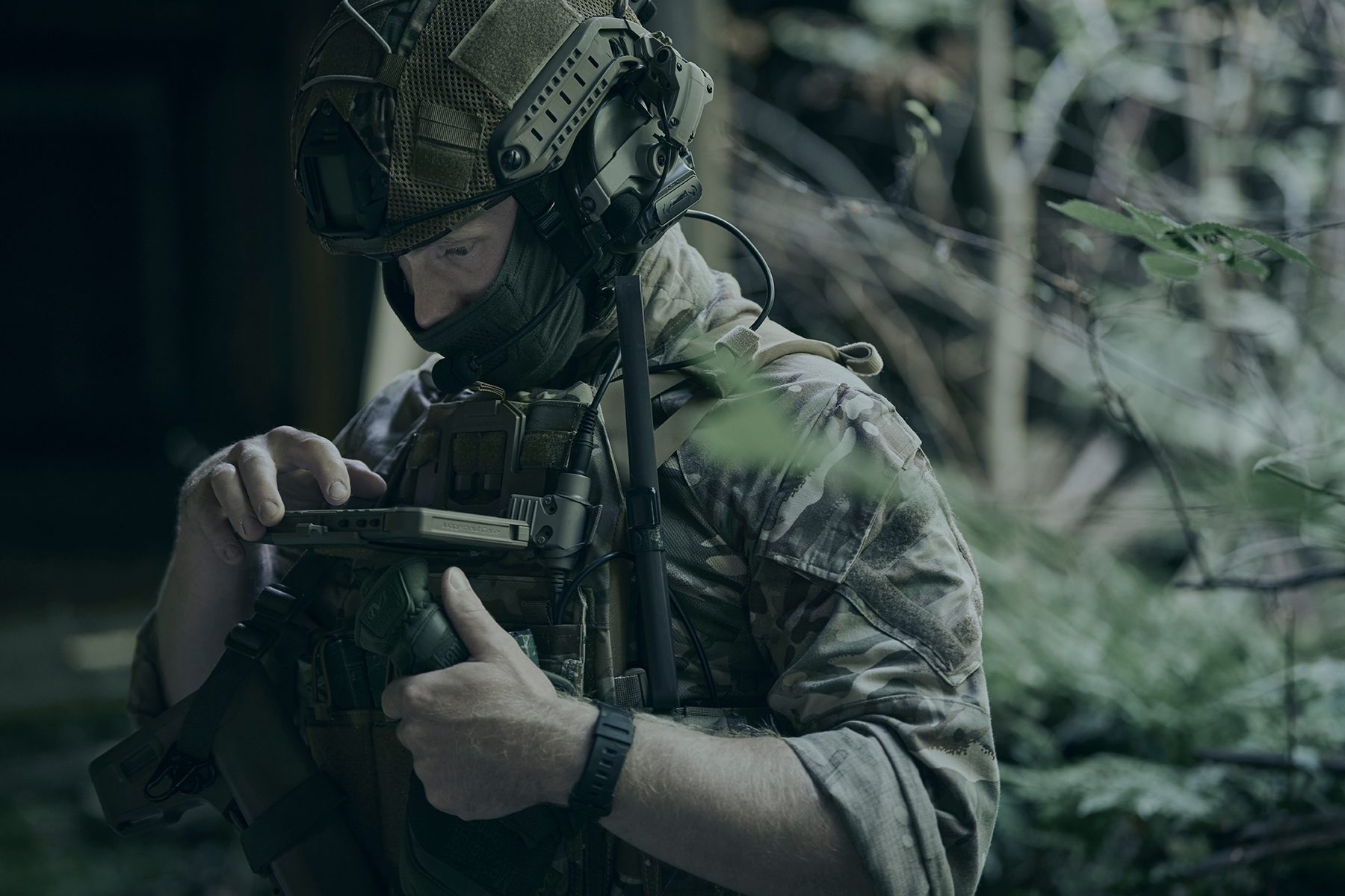 Target acquisition — operator with ATAK device in forest setting